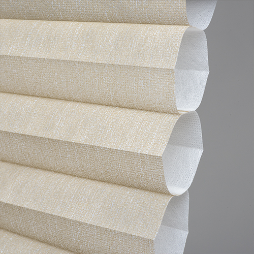 Close-up of beige honeycomb shades, showcasing the unique cellular structure that provides insulation and light control.