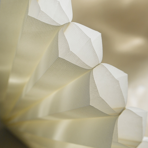 Close-up of the unique honeycomb structure of Hunter Douglas Duette shades, showcasing their insulating and light-filtering properties.